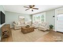 Comfortable living room featuring neutral tones, a ceiling fan, and natural light from a large window at 127 Bristol Rd, Statesville, NC 28677