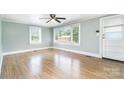Bright, airy living room with hardwood floors, large windows, and a paneled wall at 127 Bristol Rd, Statesville, NC 28677