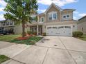 Charming two-story home with a well-manicured lawn, two car garage, and lovely stone accents at 1307 Farm Branch Sw Dr, Concord, NC 28027