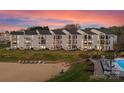 Waterfront condos featuring manicured grounds, sandy beach, lake access, and community pool at 17811 Half Moon Ln # E, Cornelius, NC 28031