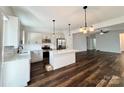 An open concept kitchen boasts stainless steel appliances, modern white cabinetry, and a center island at 211 Surrey Oak Ln, Charlotte, NC 28216