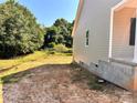 Side yard view of new construction home with concrete foundation and a partially fenced in yard at 3506 14Th Sw Ave, Hickory, NC 28602