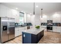 Modern kitchen with stainless steel appliances, island, and ample cabinet space at 7039 Executive Cir, Denver, NC 28037