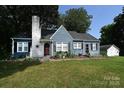 Charming blue single-Gathering home with white-painted brick, red door, and beautiful landscaping at 792 W Nc Hwy 150 St, Lincolnton, NC 28092