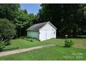 Detached white garage with a large lawn and a walkway leading up to it at 792 W Nc Hwy 150 St, Lincolnton, NC 28092