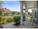Inviting front porch with rocking chair and hanging flower baskets at 958 Skywater Dr, Fort Mill, SC 29715