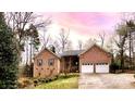 Charming brick home with a well-manicured lawn and an attached two-car garage at 9600 Lockhorn Ct, Mint Hill, NC 28227
