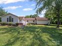 View of home with a large backyard featuring lush green grass and mature trees at 1302 Hawthorne Rd, Lancaster, SC 29720