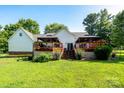 Expansive backyard with a well-maintained lawn, deck, and privacy fence at 135 Primrose Dr, Salisbury, NC 28147