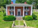 Elegant two-story brick home featuring stately columns, a covered porch, and well-manicured landscaping at 15 Kings Mountain St, York, SC 29745