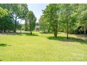 Expansive front yard with mature trees offering shade and curb appeal at 1920 E Nc Hwy 24/27 None, Biscoe, NC 27209