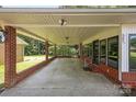 Spacious covered parking with brick foundation, suitable for multiple vehicles with backyard views at 207 W 21St St, Kannapolis, NC 28081