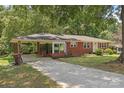 Well-maintained brick home with covered parking and a paved driveway at 207 W 21St St, Kannapolis, NC 28081