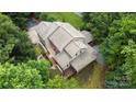 Detailed aerial view of a multi-story home showcasing roof lines, decks, landscaping and surrounding trees at 2156 Wedgewood Dr, Matthews, NC 28104
