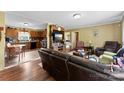 Inviting living room featuring hardwood floors, comfortable seating, and seamless flow into the kitchen at 223 Green Meadows Dr, Kings Mountain, NC 28086