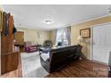 Comfortable living room with a plush rug, hardwood floors, and bright natural light at 223 Green Meadows Dr, Kings Mountain, NC 28086