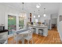 Bright, open kitchen featuring white cabinets, stainless appliances, and a breakfast bar at 2358 Sparrow Dr, Rock Hill, SC 29732