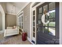 Inviting front porch featuring a cozy porch swing and stylish decor details at 2455 Talbot Ct, Sherrills Ford, NC 28673
