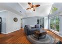 Open-concept living room with vaulted ceiling, hardwood floors, and access to the backyard at 2510 Cranbrook Ln, Charlotte, NC 28207