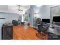 Cozy living room featuring hardwood floors, vaulted ceiling, and a work space at 2510 Cranbrook Ln, Charlotte, NC 28207