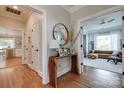 Inviting hallway featuring hardwood floors, stylish decor, and entryways leading to kitchen and living room at 2936 Saintfield Pl, Charlotte, NC 28270