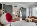 Bright living room with modern furniture, accent rug, and sliding barn doors leading to the dining area at 2936 Saintfield Pl, Charlotte, NC 28270