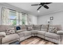 Spacious living room features a comfortable sectional sofa, a ceiling fan and natural light at 3545 Yorkland Dr, Hickory, NC 28601
