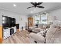 Inviting living room featuring a sectional sofa, modern ceiling fan, and stylish decor at 3545 Yorkland Dr, Hickory, NC 28601