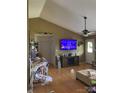 Cozy living room with a large TV, vaulted ceilings, hardwood floors, and ceiling fan at 3810 Spike Ln, Vale, NC 28168