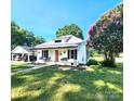 Charming single-story home with a metal roof, covered porch, and mature landscaping at 402 Madison St, Lincolnton, NC 28092