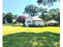 View of the back of the house showing the spacious yard, carport and mature trees at 402 Madison St, Lincolnton, NC 28092