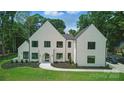 Modern home boasts crisp white facade, manicured lawn and elegant landscaping at 4208 Antioch Church Rd # 1, Weddington, NC 28104