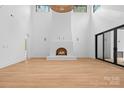 Bright, airy living room with fireplace, wood floors, and expansive windows at 4208 Antioch Church Rd # 1, Weddington, NC 28104