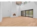 Bright living room boasts high ceilings, fireplace, and large sliding glass doors leading to an outdoor space at 4208 Antioch Church Rd # 1, Weddington, NC 28104