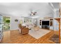 Cozy living room featuring wood floors, ceiling fan, neutral tones, and natural light at 4534 Pebblebrook Sw Cir, Concord, NC 28027