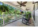 Inviting front porch with ceiling fans, swing, and ample space for relaxing at 4534 Pebblebrook Sw Cir, Concord, NC 28027