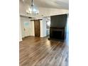 Spacious living room featuring hardwood floors, a fireplace, and a barn door at 5234 Bellflower Ln, Charlotte, NC 28227