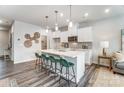Bright kitchen with white cabinets, a quartz island with seating, and stylish pendant lighting at 7126 Hodges Meadow Ln, Charlotte, NC 28213