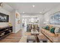 Bright living room with hardwood floors, comfortable seating and artful wall decor at 7217 Hodges Meadow Ln, Charlotte, NC 28213