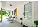 Inviting front porch with seating, offering a cozy spot to relax and enjoy the outdoors at 80 Sumner Nw Ave, Concord, NC 28027