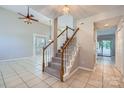 Bright foyer featuring tile floors, stairs with wood railings, and an open floor plan at 8909 Elkins Park Dr, Matthews, NC 28105