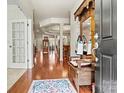 Inviting foyer with hardwood floors, an antique hall tree, and views into the living spaces at 1036 Foreman Ct, Denver, NC 28037