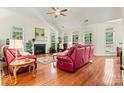 Bright living room featuring hardwood floors, a fireplace, and large windows with natural light at 1036 Foreman Ct, Denver, NC 28037