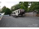 Columbus RV on gravel lot with access ramp, ready for adventure and relaxation at 114 Redwood Trl, Mount Gilead, NC 27306
