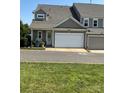 Spacious two-car garage with white door and neutral colored exterior at 11608 Founders Park Ln, Pineville, NC 28134