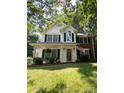 Inviting two-story home with a brick and siding exterior, American flag, and well-kept lawn at 12623 Levins Hall Rd, Huntersville, NC 28078