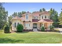 Elegant two-story home boasting a charming facade, manicured lawn and symmetrical design at 149 Vista Bluff Ln, Mooresville, NC 28117