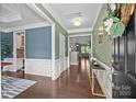 Bright and airy foyer with hardwood flooring, elegant wainscoting, and a seamless flow to the living spaces at 15211 Colonial Park Dr, Huntersville, NC 28078
