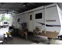 An RV with a covered outdoor seating area is perfect for relaxation and entertainment at 155 Holly Harbor Trl, Mount Gilead, NC 27306