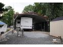The RV with attached carport provides parking and cover from the elements at 155 Holly Harbor Trl, Mount Gilead, NC 27306